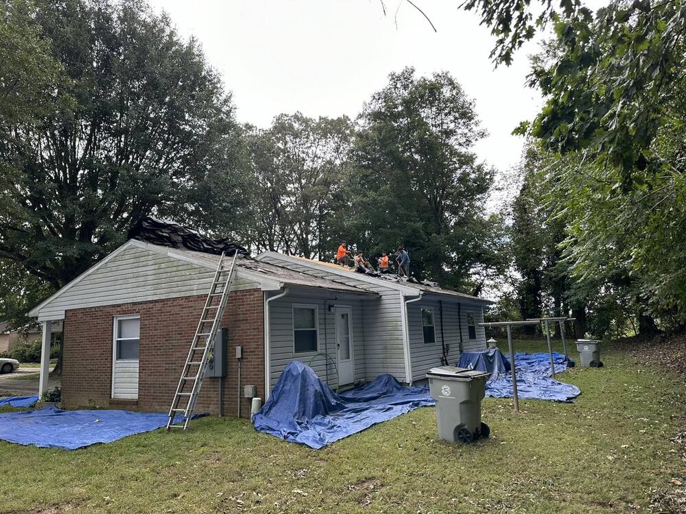 Men working on a rooftop.